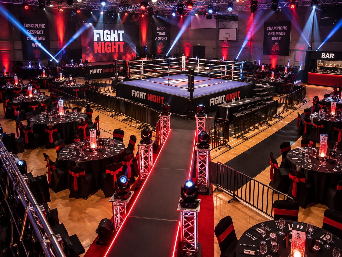 Boxing ring, LED screens and lit walk-on ramp set for a black-tie fight night