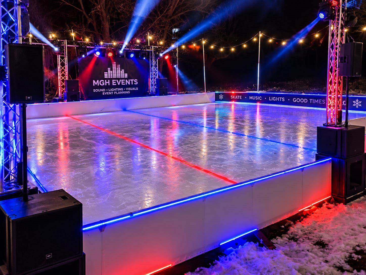 Outdoor ice rink lit with LED strips, moving heads and MGH Events branding
